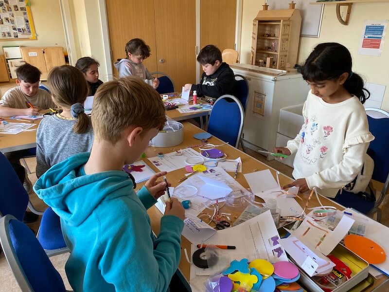 Children building a paper circuit.