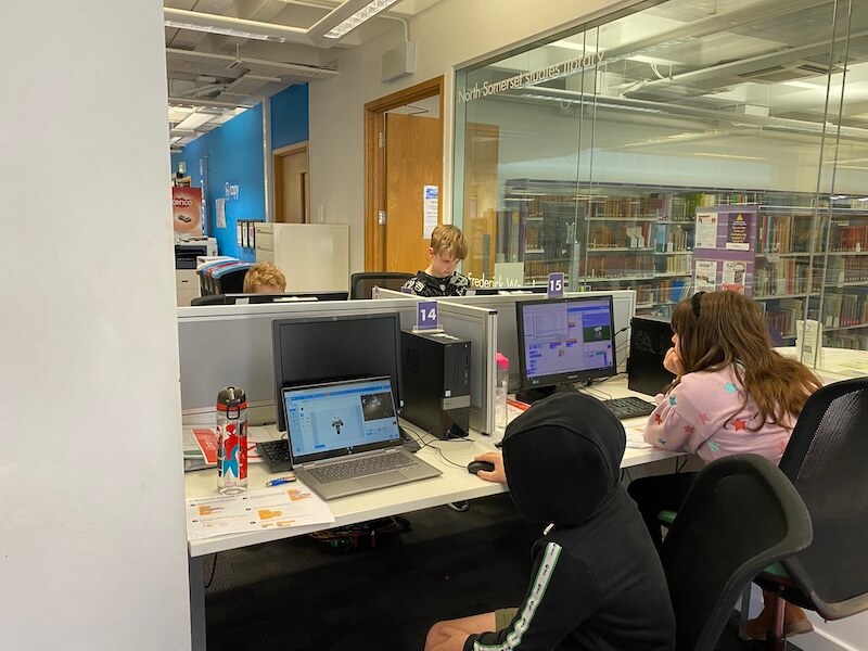 Children coding a Minecraft game in Scratch.