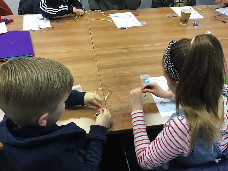 Children learning basics of electronics